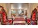 Formal dining and living area with luxurious furnishings, elegant chandeliers, and coffered ceilings for upscale living at 14507 W Christy Dr, Surprise, AZ 85379