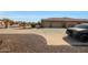 Desert landscaped front yard with circular driveway and a three-car garage at 14507 W Christy Dr, Surprise, AZ 85379