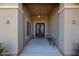 Elegant entryway featuring a chandelier and double doors with wrought iron detailing, creating a grand entrance at 14507 W Christy Dr, Surprise, AZ 85379