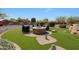An outdoor fire pit with comfortable seating, lush landscaping, and impeccable design elements at 14507 W Christy Dr, Surprise, AZ 85379