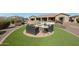 A cozy backyard fire pit area with comfortable seating, set against a beautifully landscaped backdrop at 14507 W Christy Dr, Surprise, AZ 85379