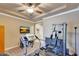 Bright fitness room features a treadmill, weight machine, and a TV for entertainment during workouts at 14507 W Christy Dr, Surprise, AZ 85379