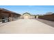 Detached garage with a large concrete driveway and desert landscaping at 14507 W Christy Dr, Surprise, AZ 85379