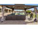 Stylish gazebo with ample seating overlooking the pool area, ideal for outdoor relaxation and socializing at 14507 W Christy Dr, Surprise, AZ 85379
