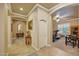 Elegant hallway with tiled floors leading to a fitness room equipped with exercise equipment at 14507 W Christy Dr, Surprise, AZ 85379