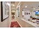 Hallway with detailed archway, opening to game room with a pool table at 14507 W Christy Dr, Surprise, AZ 85379