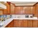 Close-up of kitchen features custom wood cabinets and marble countertops with subway tile backsplash at 14507 W Christy Dr, Surprise, AZ 85379
