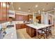 Bright kitchen with custom cabinets, white backsplash, and a large central island at 14507 W Christy Dr, Surprise, AZ 85379