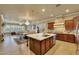 Open concept kitchen with a large island, stainless steel appliances, and wood cabinetry at 14507 W Christy Dr, Surprise, AZ 85379