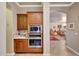 Kitchen detail showing built-in oven and microwave, with easy access to the living room at 14507 W Christy Dr, Surprise, AZ 85379