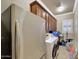Well-equipped laundry room featuring ample cabinet space, washer, and dryer, with neutral wall color at 14507 W Christy Dr, Surprise, AZ 85379