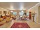 Formal living area with luxurious furnishings, an elegant chandelier, and decor for upscale living at 14507 W Christy Dr, Surprise, AZ 85379