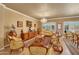 Elegant living room featuring a chandelier, ornate furniture, and plenty of natural light at 14507 W Christy Dr, Surprise, AZ 85379