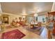 Formal living and dining area with luxurious furnishings, elegant chandeliers, and neutral tones throughout at 14507 W Christy Dr, Surprise, AZ 85379