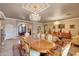 Formal living and dining area with luxurious furnishings, elegant chandeliers, and an open concept design at 14507 W Christy Dr, Surprise, AZ 85379