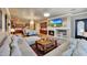 Open concept living room with fireplace, dining area, bar, and kitchen at 14507 W Christy Dr, Surprise, AZ 85379