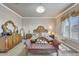 Charming main bedroom featuring a crystal chandelier and decorative wall paper at 14507 W Christy Dr, Surprise, AZ 85379