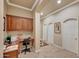 A home office with tiled floors, built-in desk, cabinets, and arched doorways at 14507 W Christy Dr, Surprise, AZ 85379
