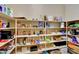 Spacious pantry with shelves stocked with an assortment of food items, including snacks and canned goods at 14507 W Christy Dr, Surprise, AZ 85379