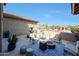 Relaxing outdoor patio area featuring a fountain, comfortable seating, and a cozy fire pit for entertaining guests at 14507 W Christy Dr, Surprise, AZ 85379