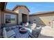 Spacious outdoor patio with a fire pit, seating area, fountain feature, and a view of the beautiful surroundings at 14507 W Christy Dr, Surprise, AZ 85379