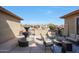 Relaxing outdoor patio area featuring a fountain, comfortable seating, and a cozy fire pit for entertaining guests at 14507 W Christy Dr, Surprise, AZ 85379