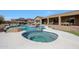 A backyard pool and patio with a gazebo and a view of the home's exterior and surrounding landscaping at 14507 W Christy Dr, Surprise, AZ 85379