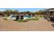 A backyard pool with a patio featuring inviting seating, with lush landscaping and a well-maintained patio at 14507 W Christy Dr, Surprise, AZ 85379