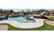 Beautiful outdoor pool with rock features and sun loungers with patio, perfect for relaxing and entertaining at 14507 W Christy Dr, Surprise, AZ 85379