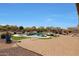 A backyard oasis with a luxurious pool, jacuzzi, outdoor seating, a gazebo, and lush landscaping at 14507 W Christy Dr, Surprise, AZ 85379
