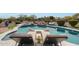 Resort-style pool with rock waterfall feature and lounge chairs, perfect for outdoor relaxation and entertaining at 14507 W Christy Dr, Surprise, AZ 85379