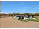 An inviting backyard pool oasis featuring a pristine pool, stone features and cozy lounge chairs at 14507 W Christy Dr, Surprise, AZ 85379