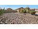 Dry riverbed landscaping featuring desert plants, boulders, and low-maintenance ground cover for easy care at 14507 W Christy Dr, Surprise, AZ 85379