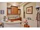 This spacious wet bar features granite countertops, wood cabinets, and decorative displays at 14507 W Christy Dr, Surprise, AZ 85379