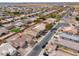 Aerial view of neighborhood, featuring a home with spacious rock landscaping, and a block fence for privacy at 1629 E Prickly Pear Pl, Casa Grande, AZ 85122