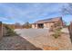Large backyard showcasing a rock landscape, mature trees, and perimeter block wall, offering ultimate seclusion at 1629 E Prickly Pear Pl, Casa Grande, AZ 85122