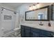 A bathroom features a double sink vanity, a large mirror, and a beautifully tiled shower at 1629 E Prickly Pear Pl, Casa Grande, AZ 85122