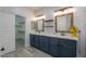 Bathroom featuring a double vanity with stylish mirrors, shelving, and modern lighting at 1629 E Prickly Pear Pl, Casa Grande, AZ 85122