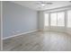 Bright bedroom featuring bay windows, a ceiling fan and wood-look floors at 1629 E Prickly Pear Pl, Casa Grande, AZ 85122