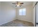 A bright bedroom features a window, ceiling fan, and a closet at 1629 E Prickly Pear Pl, Casa Grande, AZ 85122