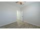 A bright bedroom has a doorway and wood-look tile flooring at 1629 E Prickly Pear Pl, Casa Grande, AZ 85122