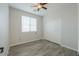 A bright bedroom features a window, ceiling fan, and a closet with sliding doors at 1629 E Prickly Pear Pl, Casa Grande, AZ 85122