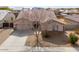 Home showcasing neutral exterior, mature landscaping, and a spacious driveway at 1629 E Prickly Pear Pl, Casa Grande, AZ 85122