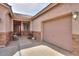 Close up exterior view of a tan stucco home with a two car garage on the right at 1629 E Prickly Pear Pl, Casa Grande, AZ 85122