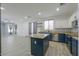 Charming kitchen with a center island, granite countertops, and modern appliances open to the living room at 1629 E Prickly Pear Pl, Casa Grande, AZ 85122