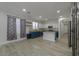 Open concept living space featuring a modern kitchen and spacious living area with wood-look floors at 1629 E Prickly Pear Pl, Casa Grande, AZ 85122