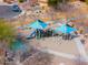 Aerial close up of a neighborhood playground with blue sun shades and multiple play features at 1629 E Prickly Pear Pl, Casa Grande, AZ 85122