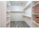 Spacious walk-in closet with built-in shelving and wooden closet rods at 1629 E Prickly Pear Pl, Casa Grande, AZ 85122
