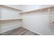 Spacious walk-in closet featuring wooden rods with gray wood flooring at 1629 E Prickly Pear Pl, Casa Grande, AZ 85122