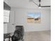 Bright bedroom featuring neutral carpet, ceiling fan, and large window letting in ample natural light at 16430 W Alameda Rd, Surprise, AZ 85387